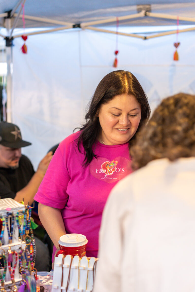 Artisan showcasing products at the mercado