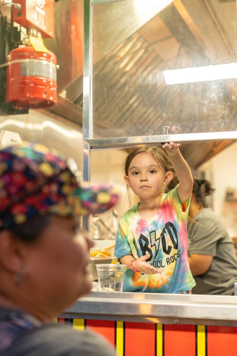 Vendors welcoming shoppers at the market